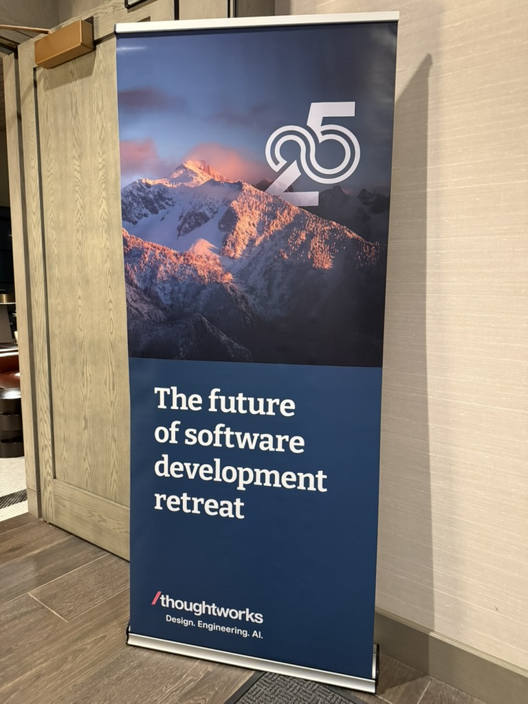 Banner with snow-capped mountains, text 'The future of software development retreat,' Thoughtworks logo, number 25.